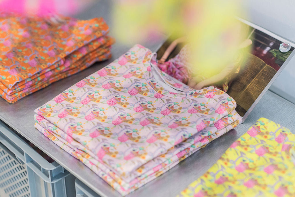 Organic cotton printed fabrics t-shirts stacked in the aesthete-(kids)wear shop in Brussels.